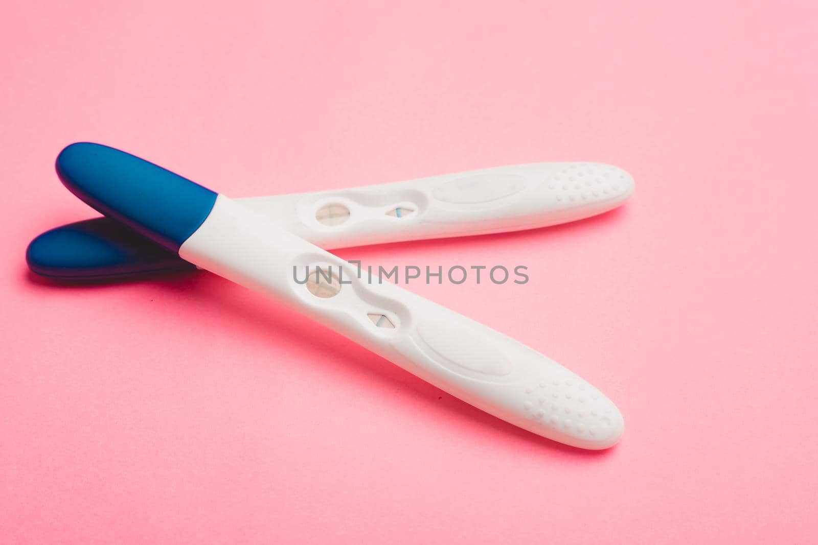 Pregnancy test on a pink background . Positive test. Pregnancy copy space. Motherhood