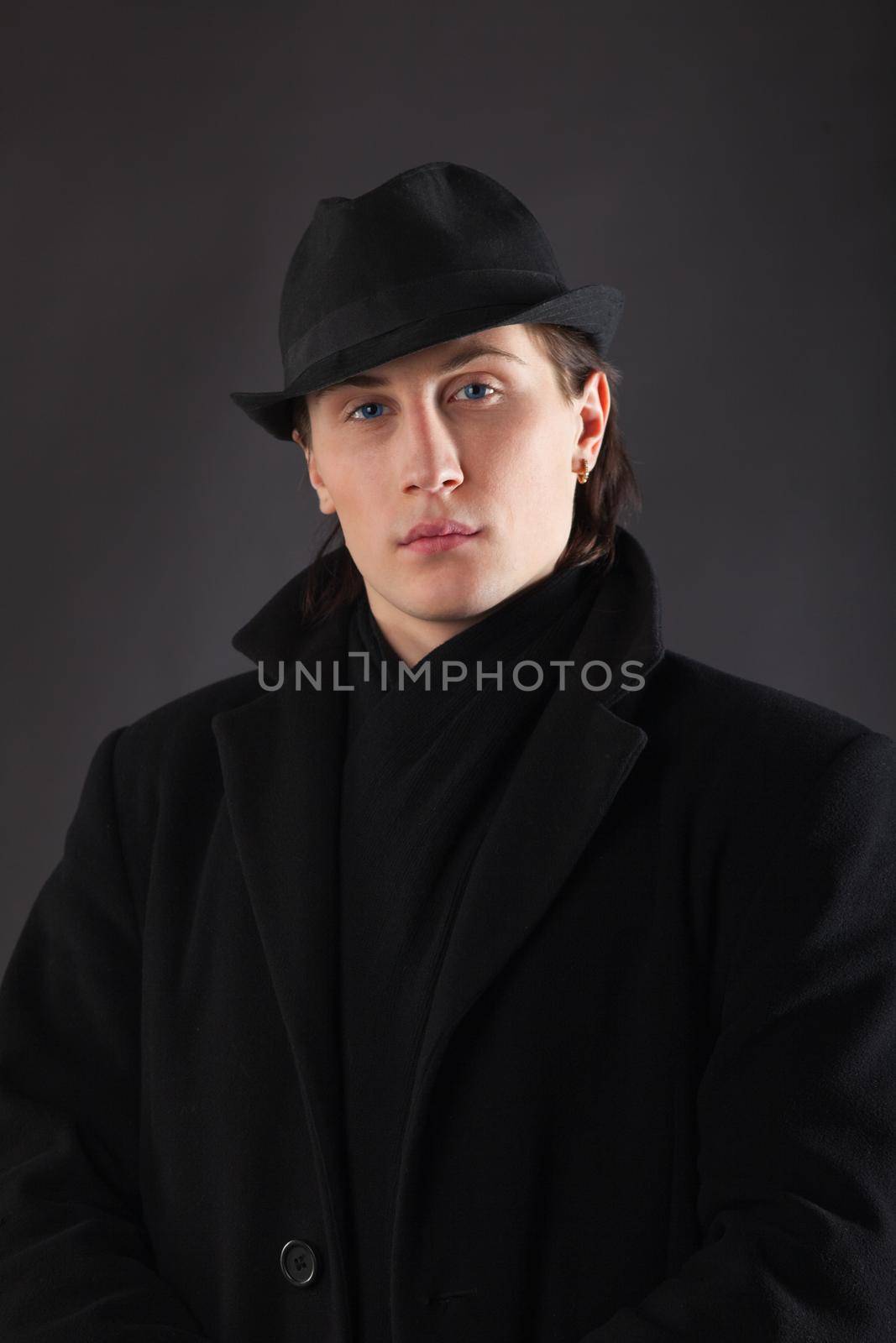 Man in black cloth and hat by rivertime