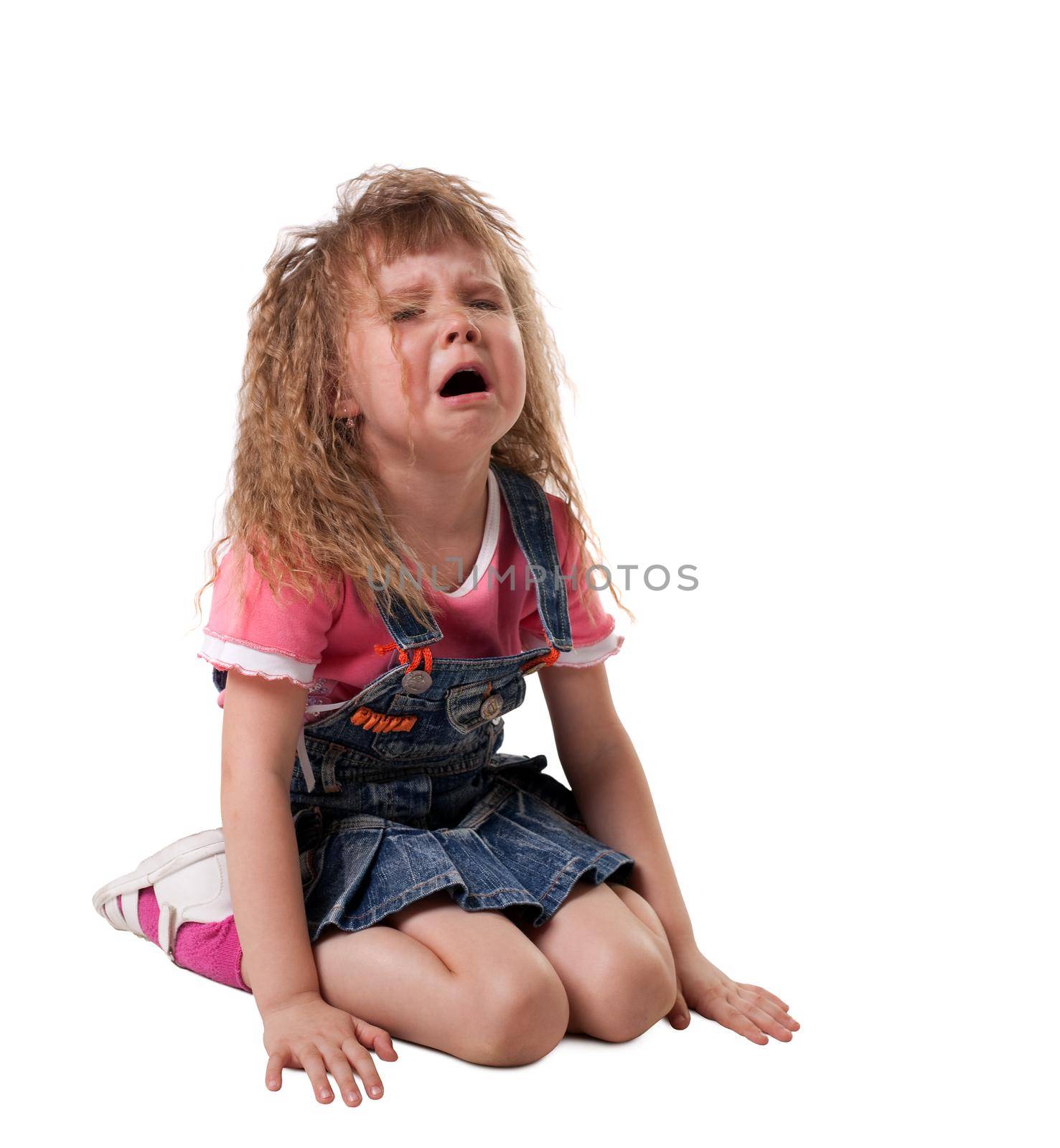 crying kid sit on white, jeans cloth - isolated