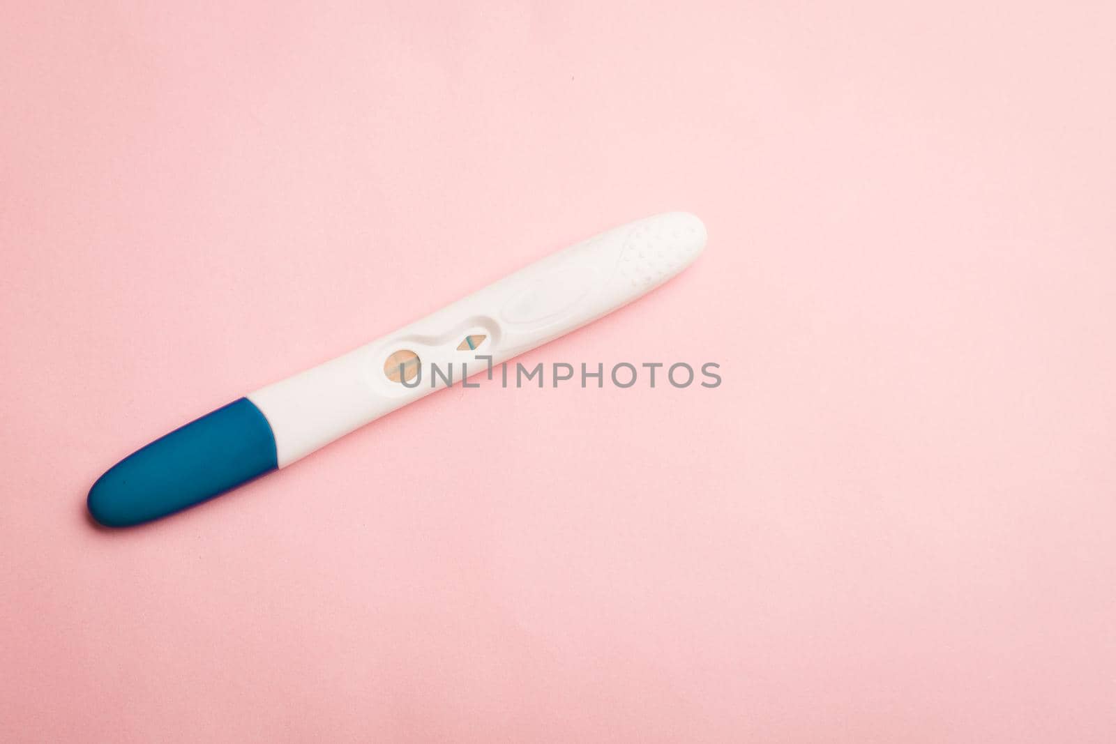 Pregnancy test on a pink background . Positive test. Pregnancy copy space. Motherhood