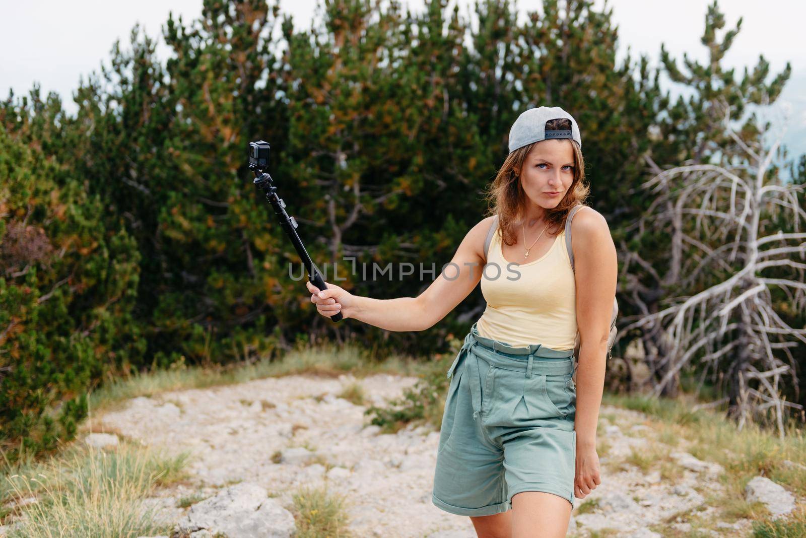 Woman traveler hipster looking forward at amazing mountains and valley view. Space for text. Wearing stylish boho fall outfit. Profile portrait of happy sporty woman relaxing in park. Joyful female model breathing fresh air outdoors. Healthy active lifestyle concept. Copy space by Andrii_Ko