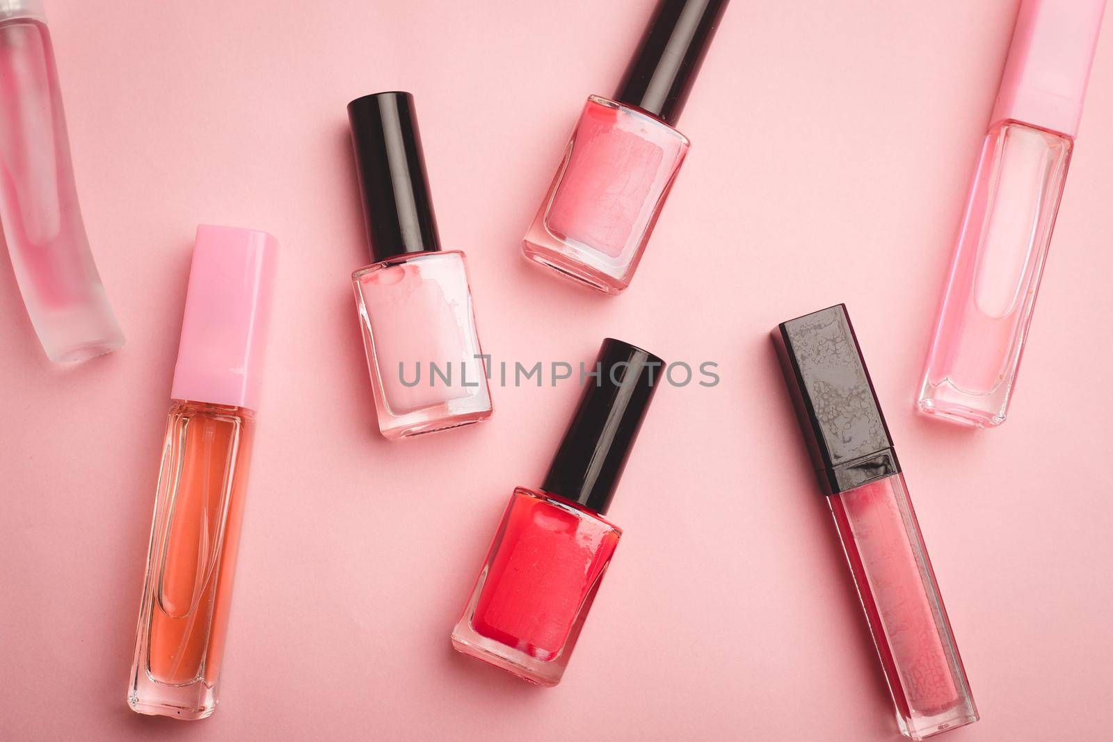 Pink nail polish on a pink copy space background. An article about nail polishes. Gel polish. An article about cosmetics. Decorative cosmetics . Pink background