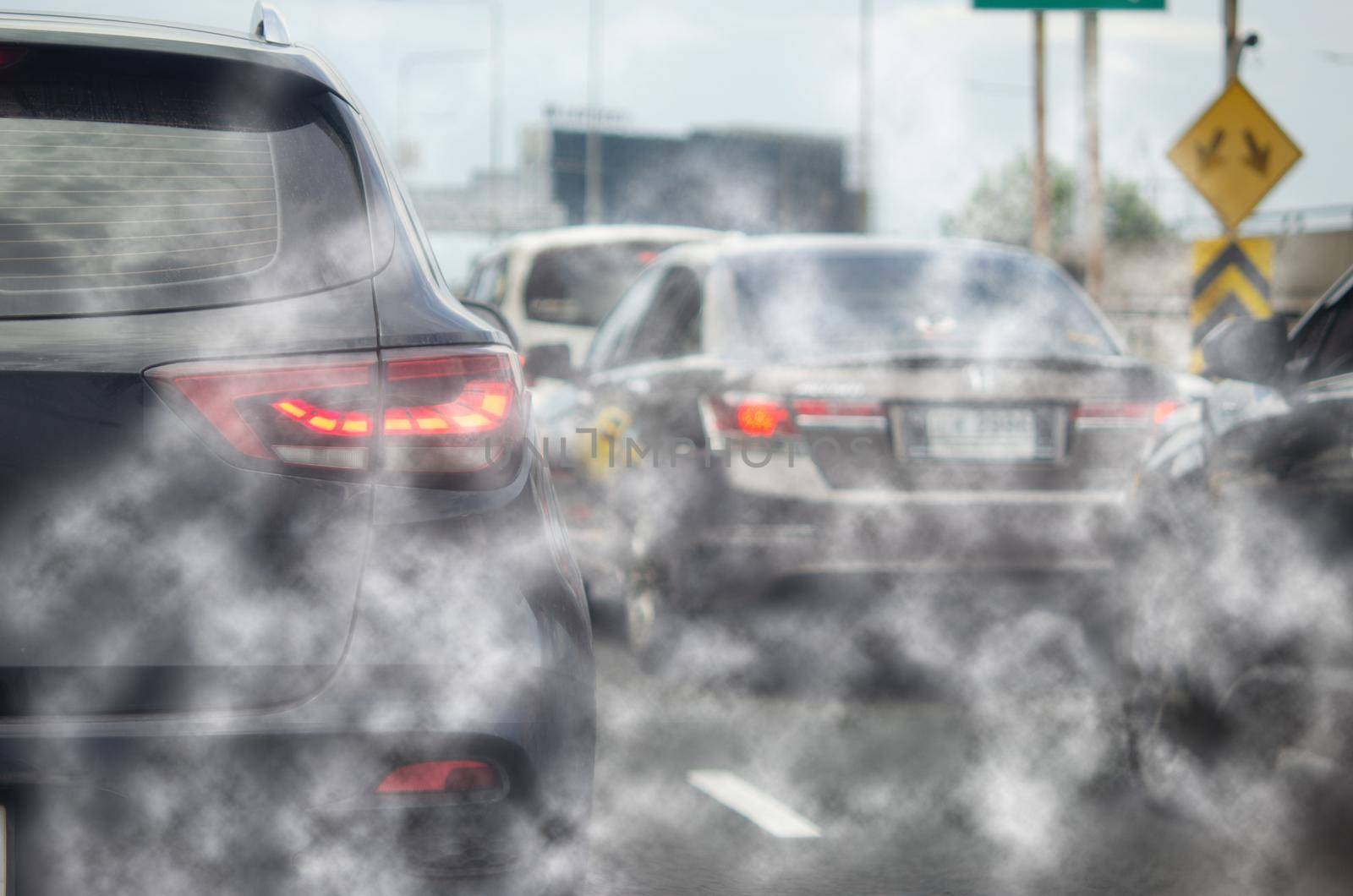 Car exhaust fumes during traffic jams on the road cause environmental emissions. by aoo3771