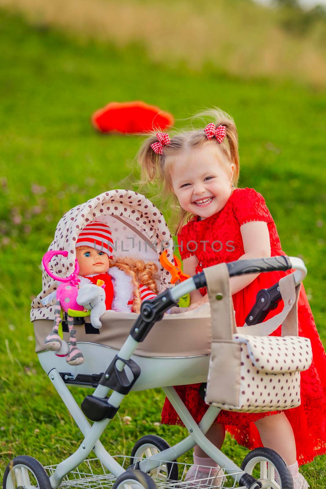 girl playing with a doll in a stroller by zokov