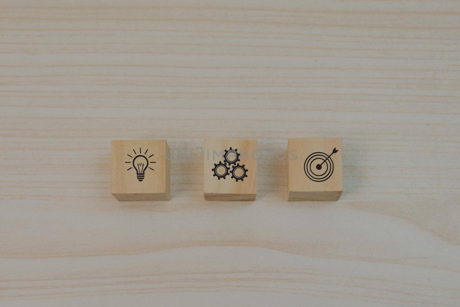 Strategy goals and investment plan business marketing icon symbol gear and light bulb with wood block cube on table. by aoo3771