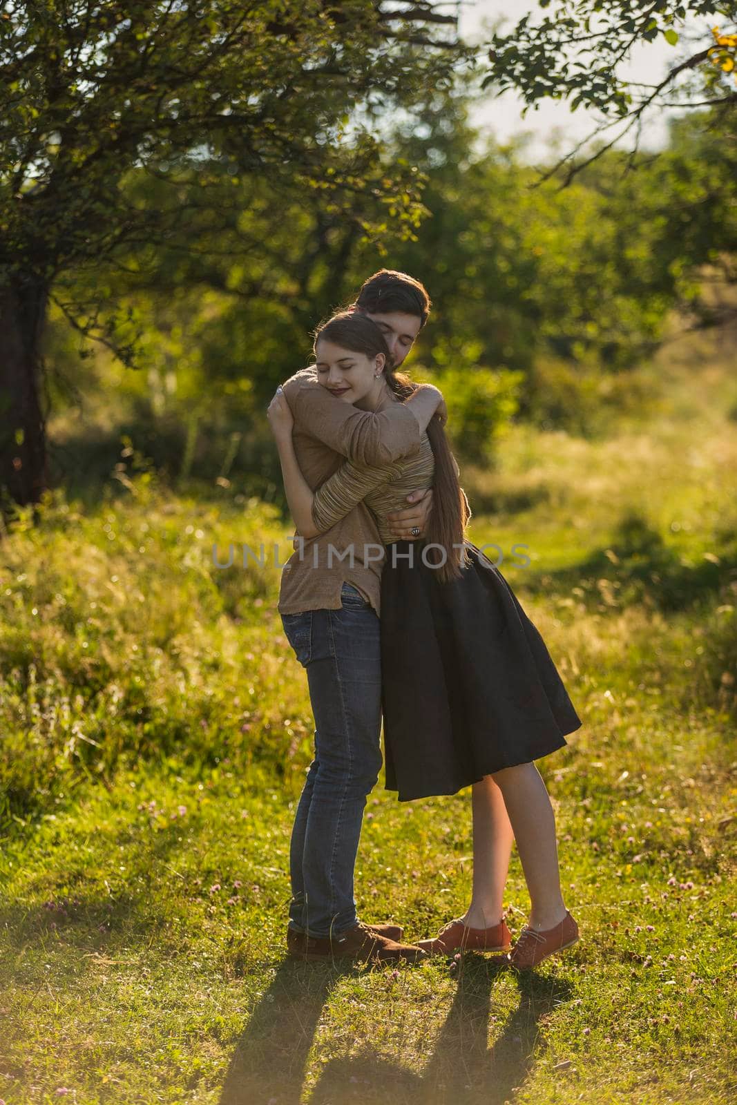 young couple hugging on nature background