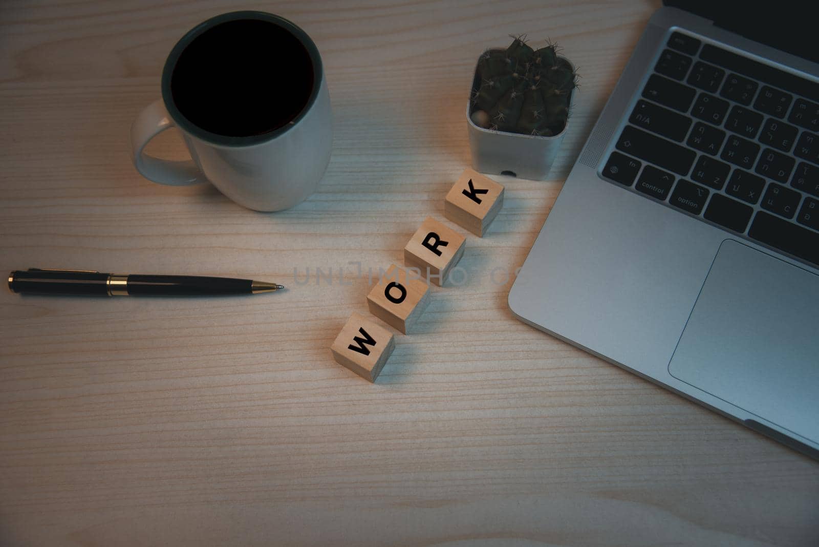 Top view copy space desk computer laptop and pen cube wood block text work and coffee on desk.