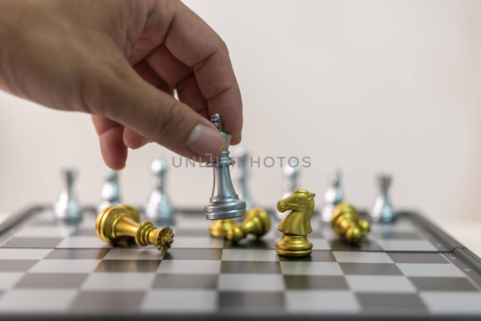 Hand man holding chess in game.Idea planning strategy marketing business concept. by aoo3771