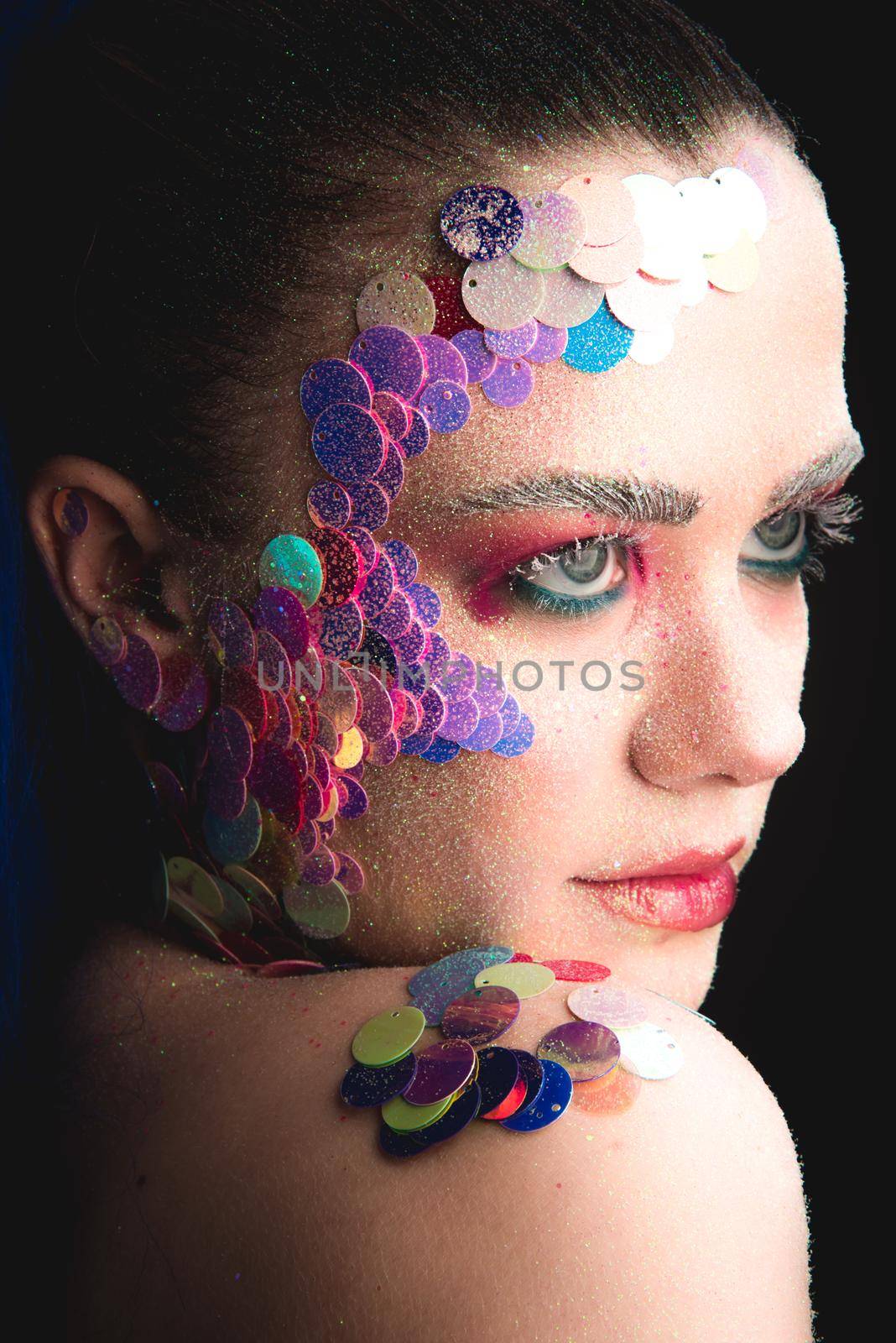 Portrait of a girl with colorful sequins makeup by Multipedia