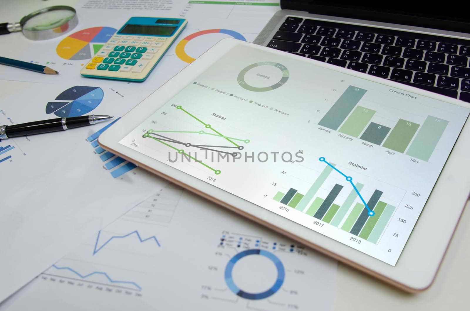 Business document graph finance report and chart marketing information digital investment analysis tablet and pen on desk. by aoo3771
