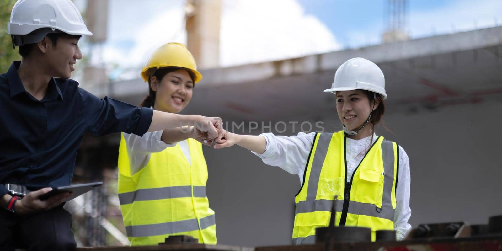 Team job of teamwork engineer work together in a construction site with business concept. by wichayada