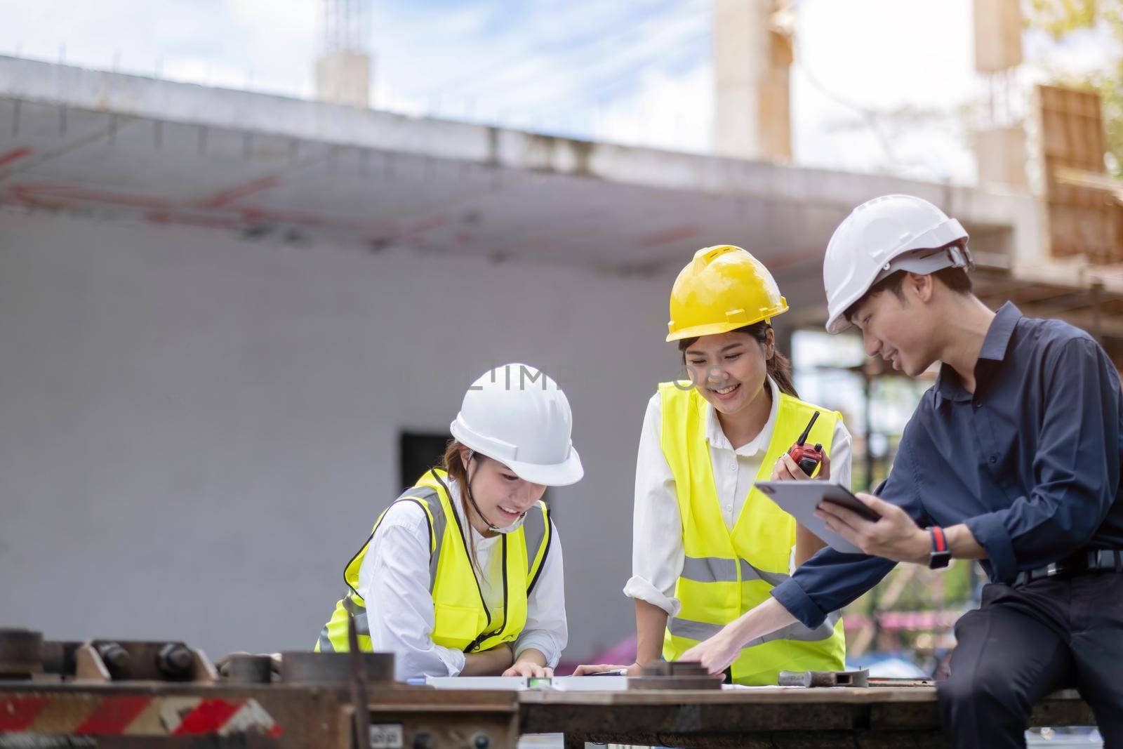 Female construction engineer. Architect with a tablet computer at a construction site. Young Woman looking, building site place on background. Construction concept.