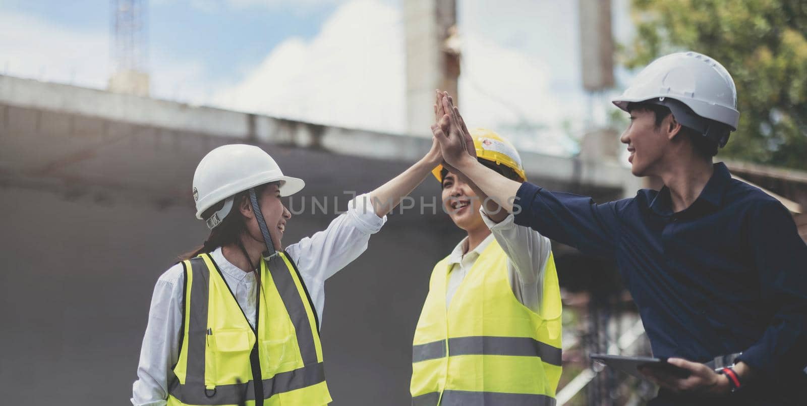 Team job of teamwork engineer work together in a construction site with business concept. by wichayada