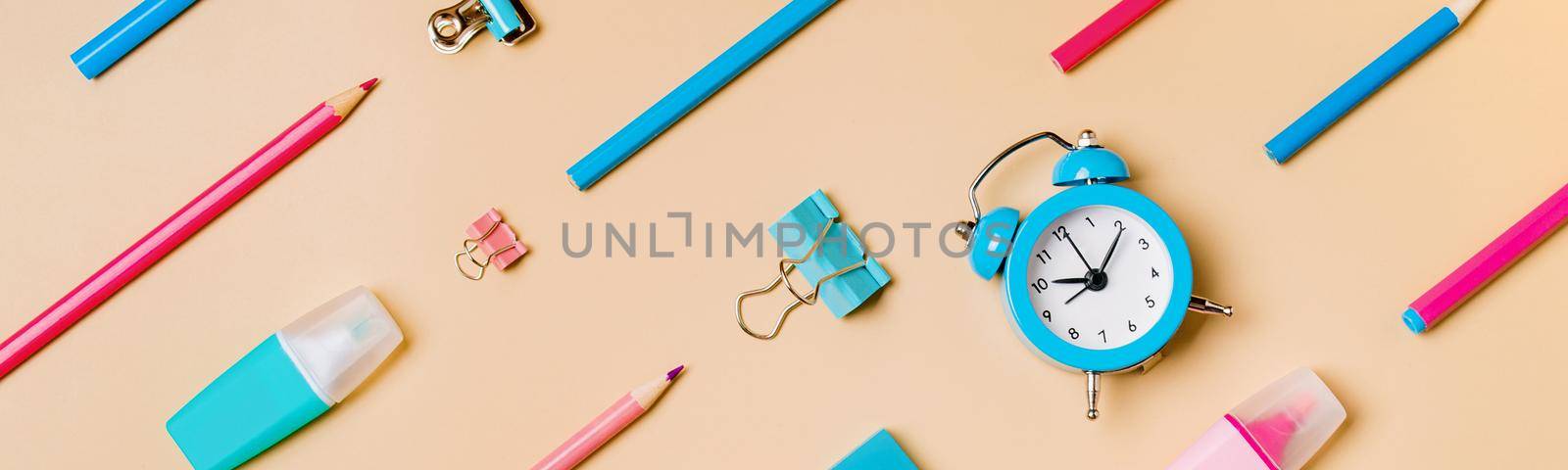 Online study, distantly learning class. Long horizontal banner with diagonal pattern from school supplies and stationery accessories. Back to school, freelancer work concept on pastel beige background