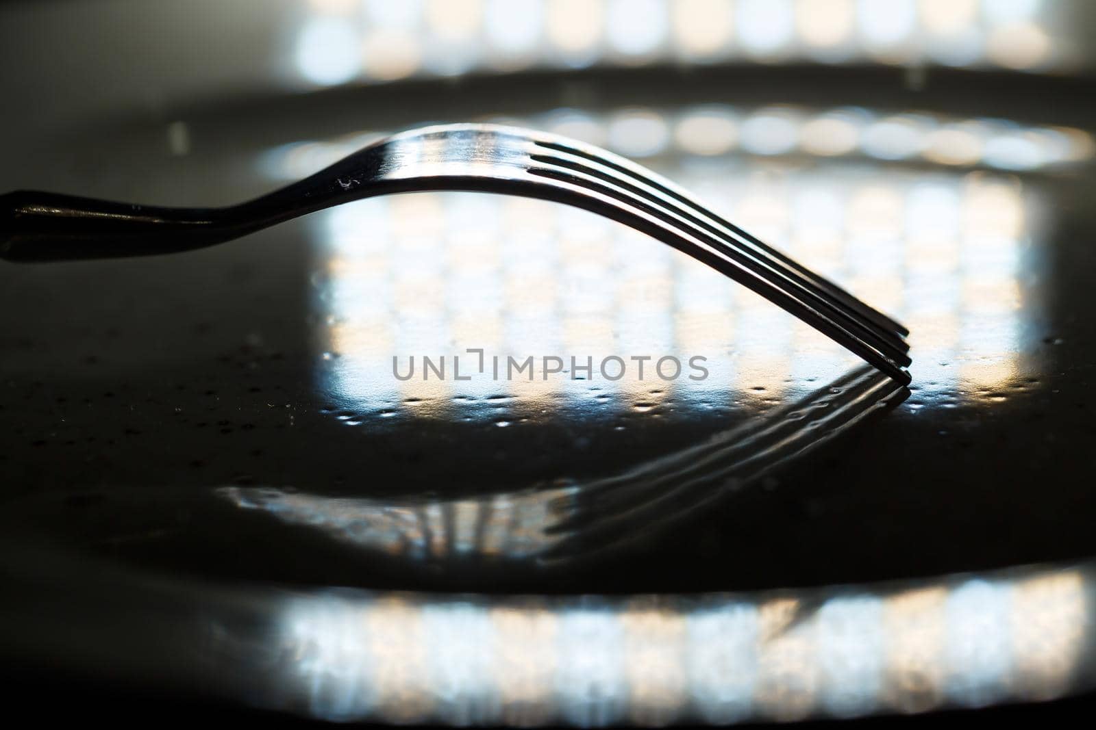 Metal forks and knives on a plate