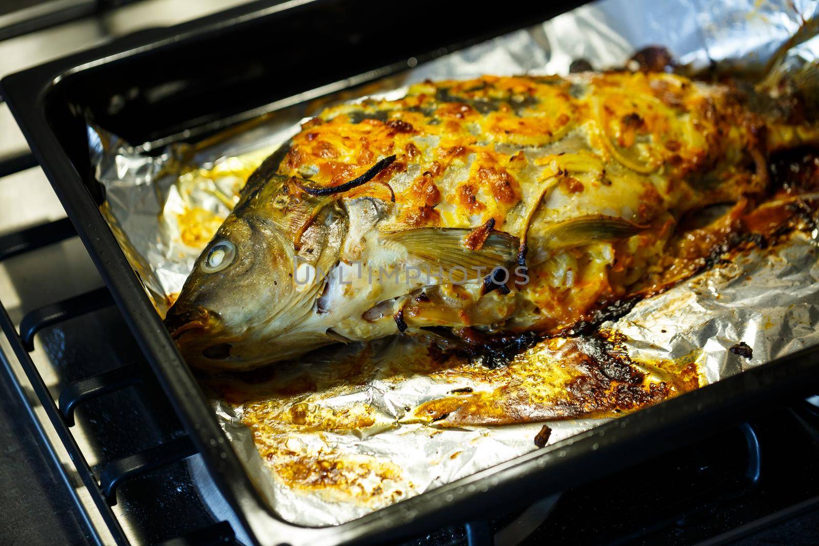 Baked fish with onions and cheese