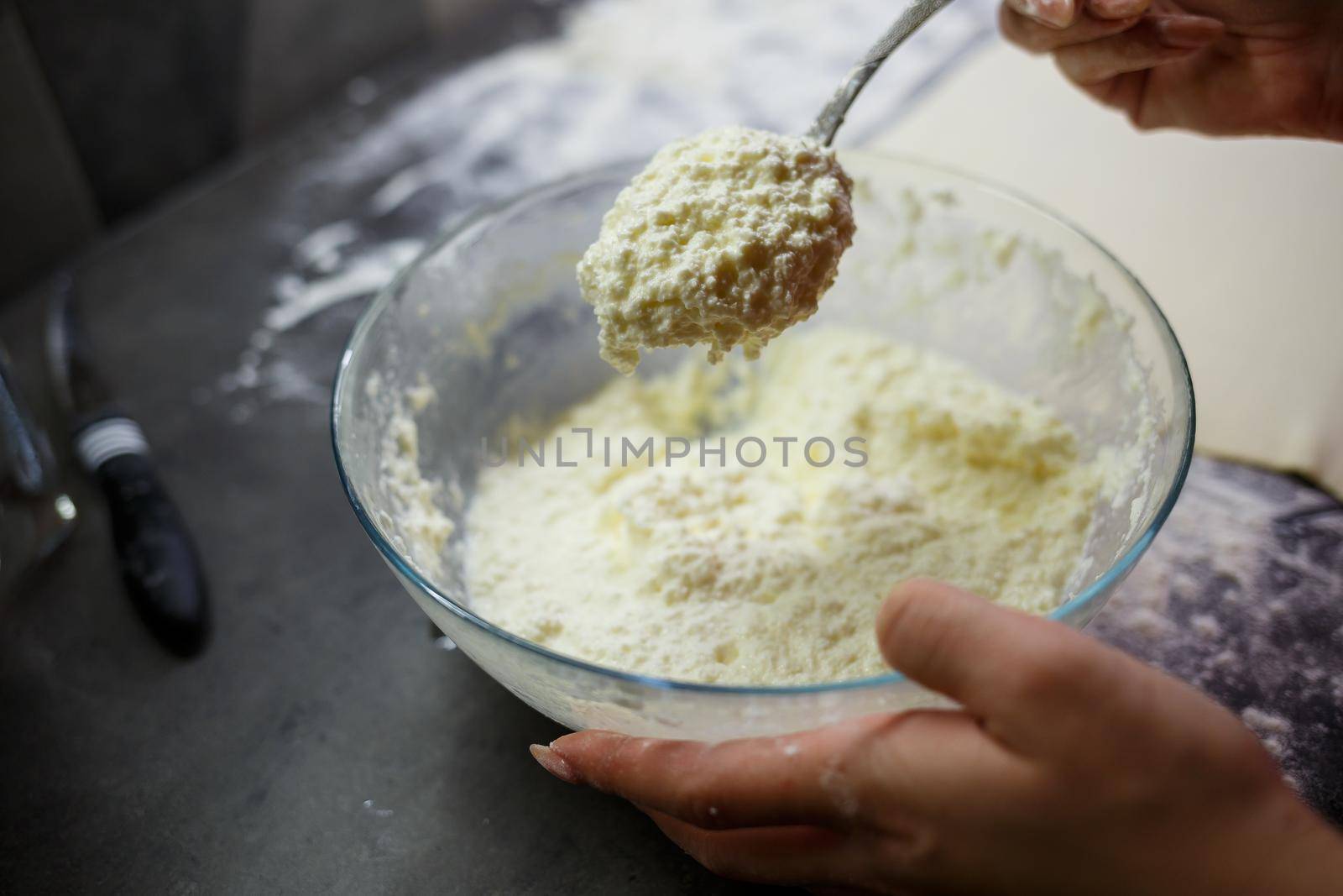 Baking domestic rolls with cheese. Putting cheese on dough for rolls