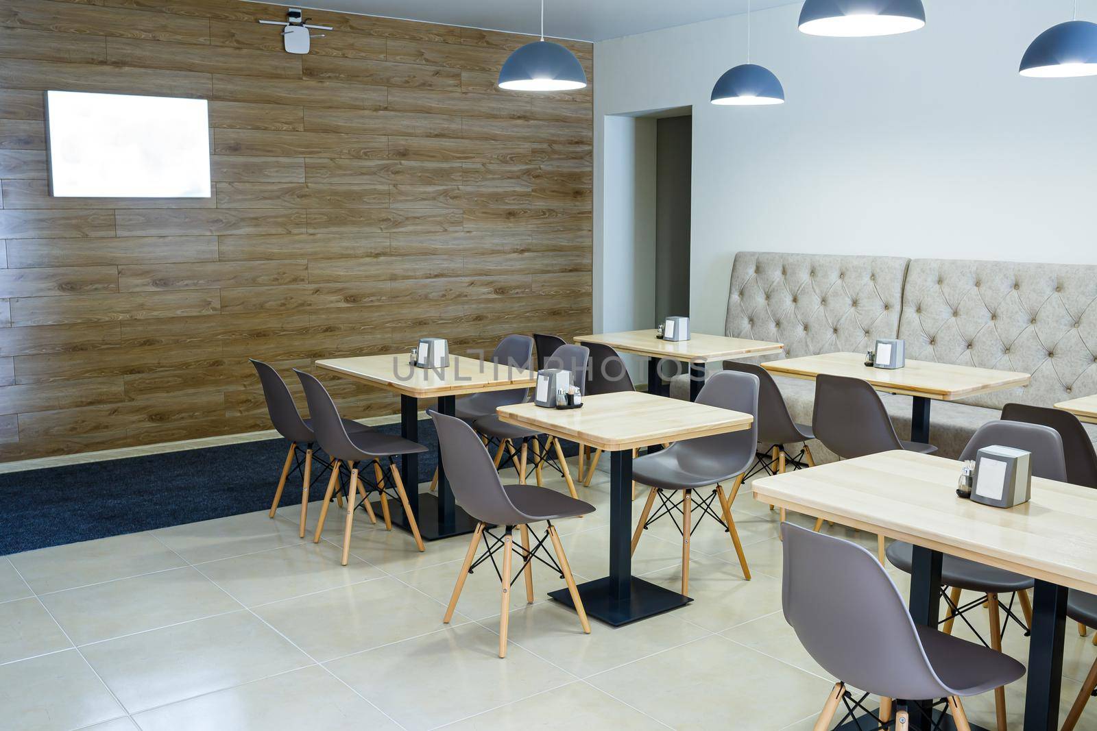 Large bright lounge with chairs, table and TV