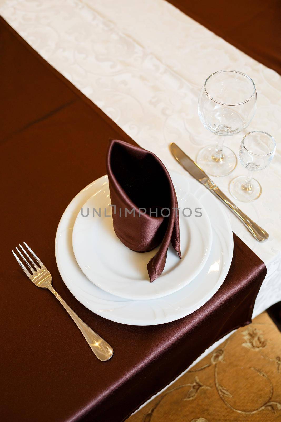 Table setting in a restaurant. Glass, plate, fork, knife