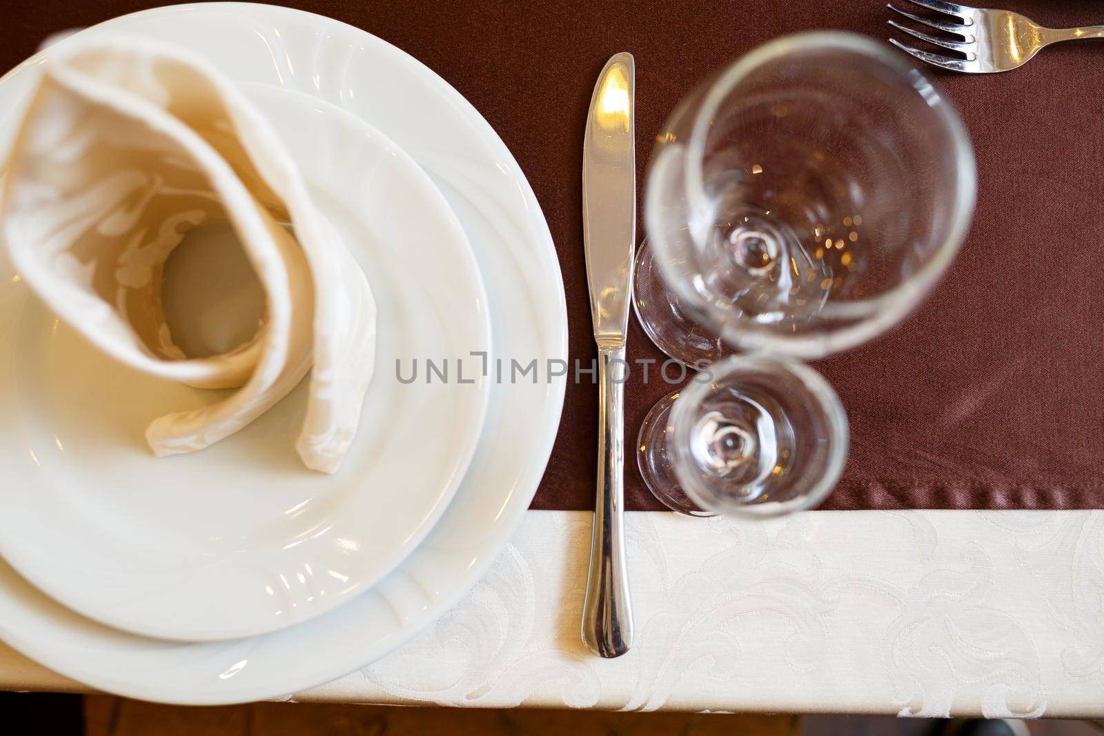 Table setting in a restaurant. Glass, plate, fork, knife