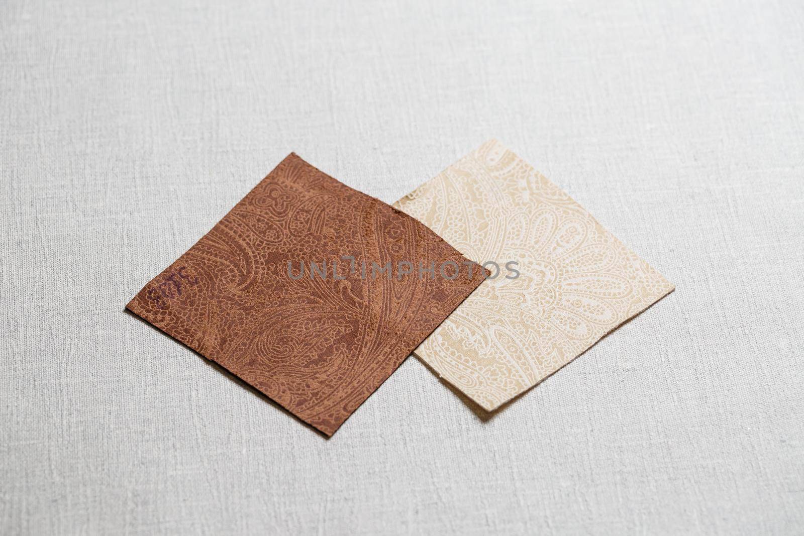 square pieces of multi-colored fabric laid out on a gray background