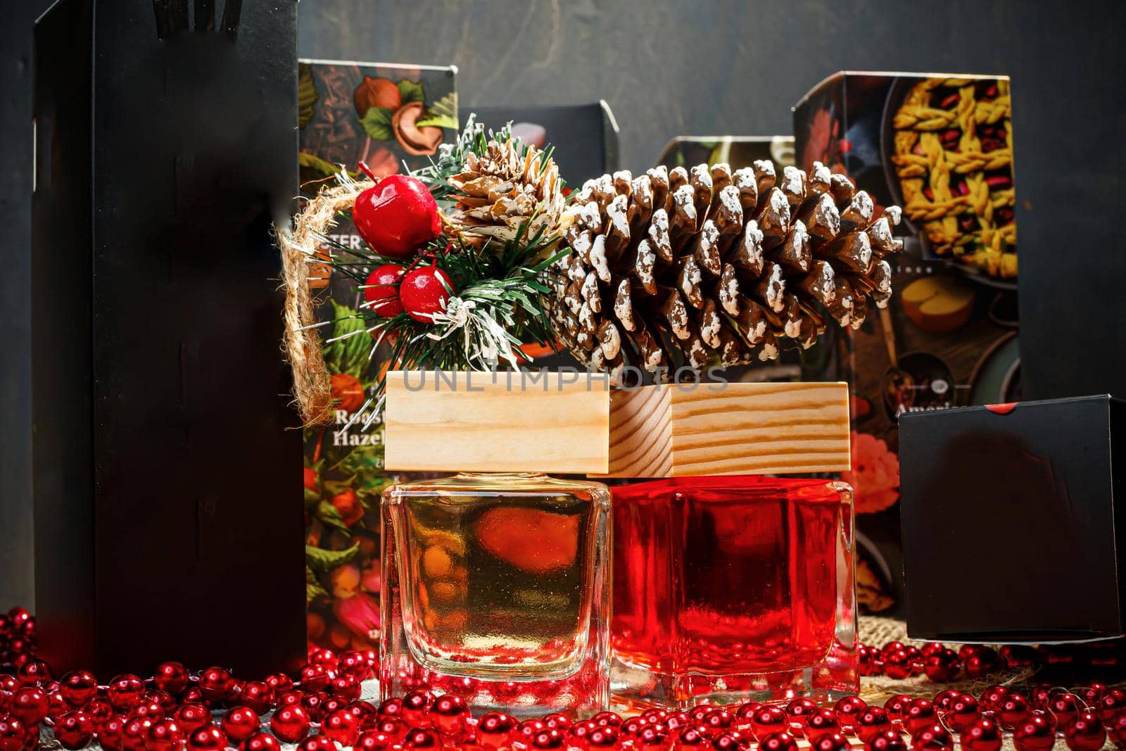 Perfume bottle New Year's gift. Stylish New Year decor perfume bottle is under the tree. Fashionable perfumes in New Year's locations. Perfumes for women