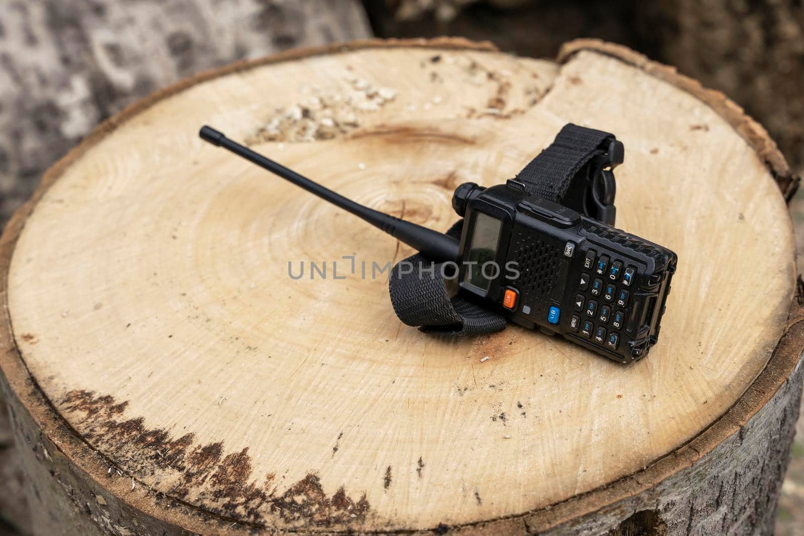 the walkie-talkie is lying on a wooden stump. Means of communication by audiznam2609