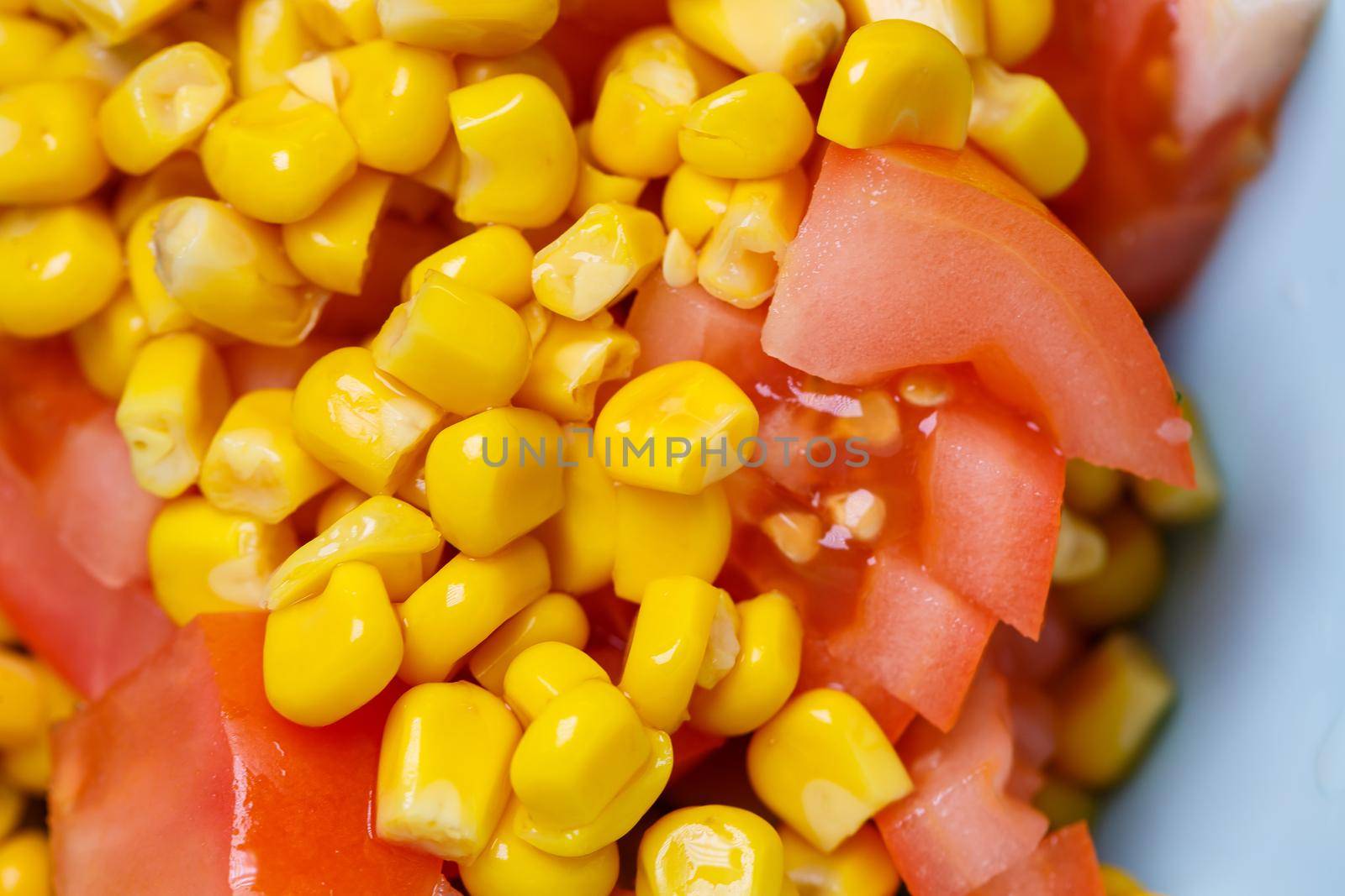 Corn salad, tomato and cucumber with olive oil. Food is proper nutrition. Vegetarian food