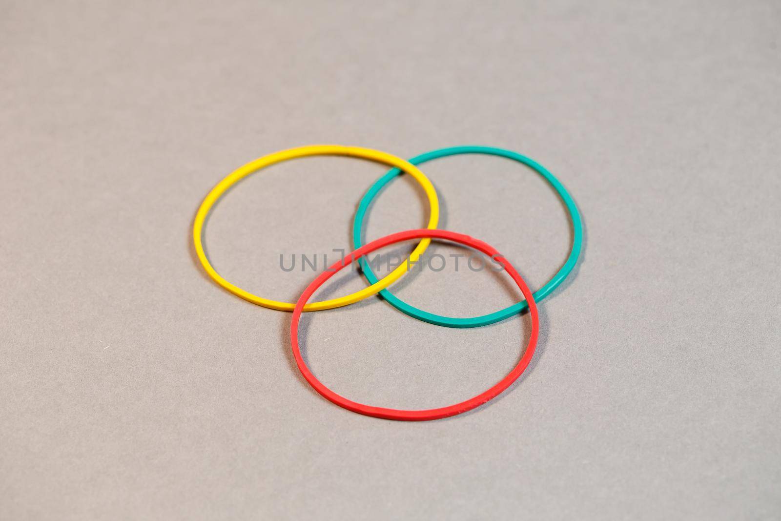 Colored rubber bands for money on a colored background. Stationery accessories