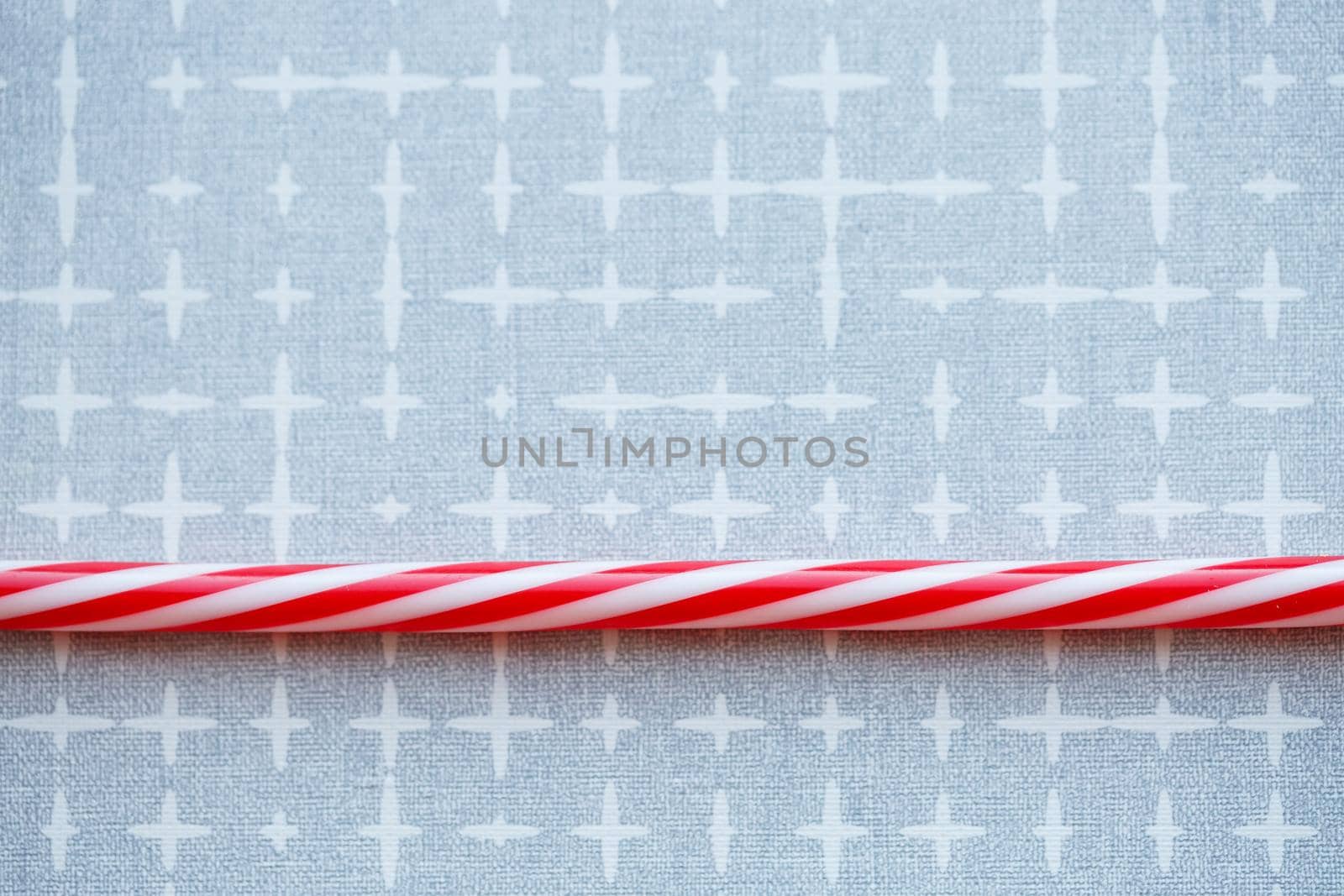 Plastic reusable straw for cocktails on a gray background
