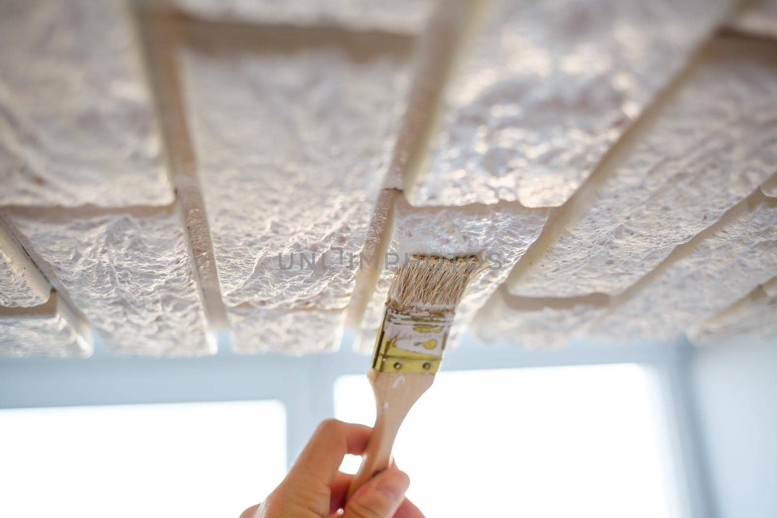 painting plaster decorative brick with white paint