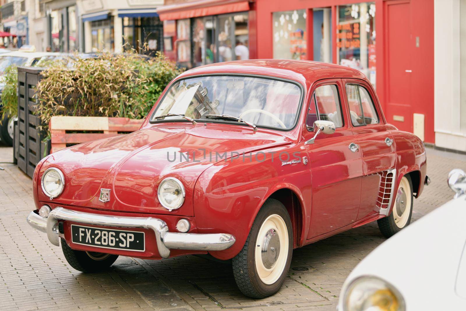 PARIS, FRANCE - MAY, 15, 2022:Vintage red Renault Dauphine in the city