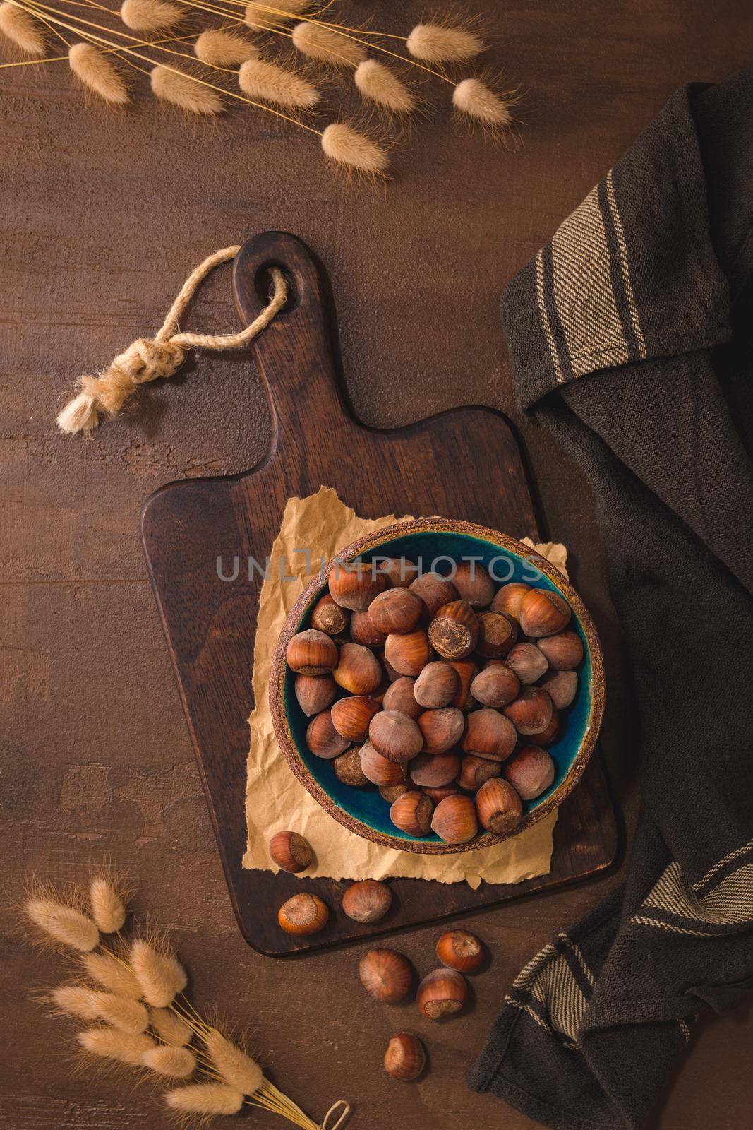 Hazelnuts in a ceramic bowl on a rustic kitchen countertop