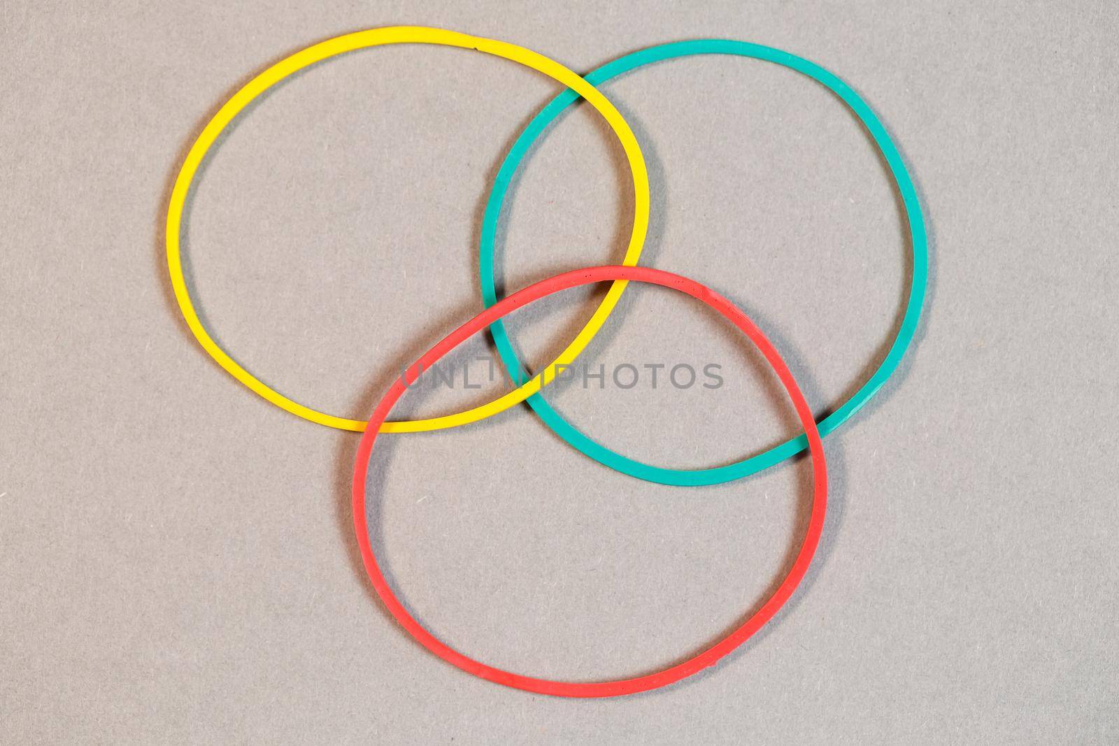 Colored rubber bands for money on a colored background. Stationery accessories