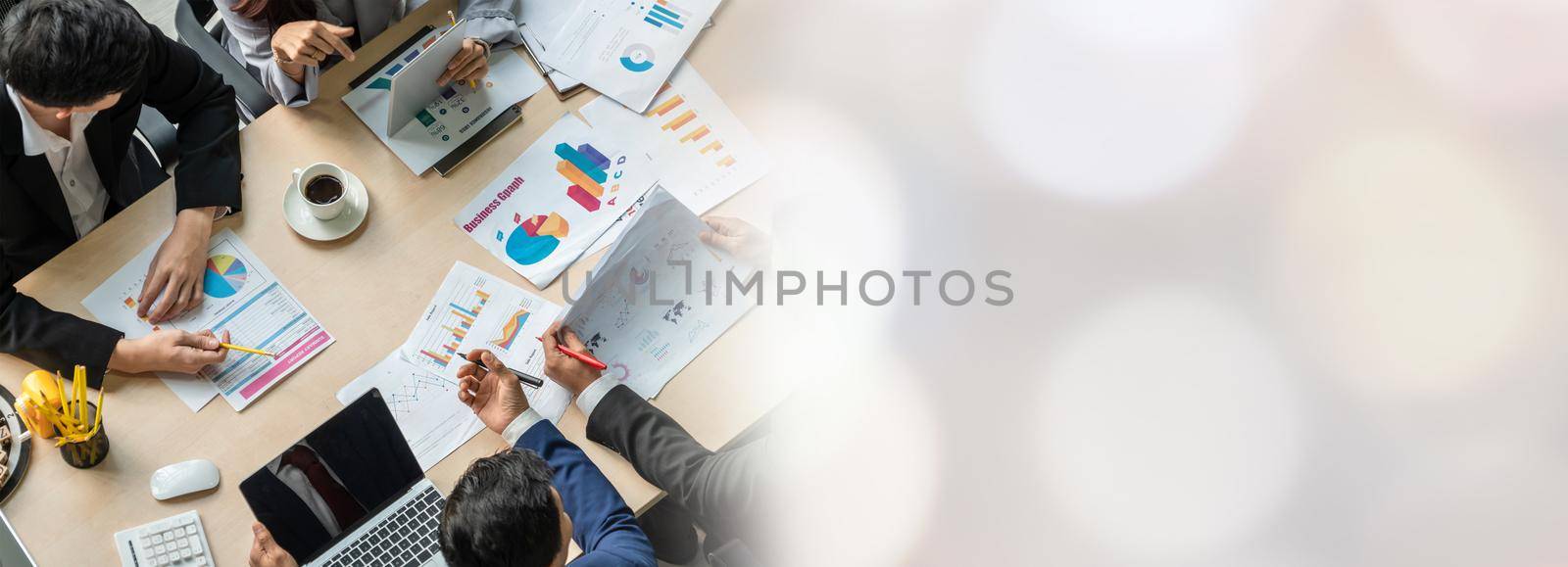 Business people group meeting shot from top widen view in office . Profession businesswomen, businessmen and office workers working in team conference with project planning document on meeting table .