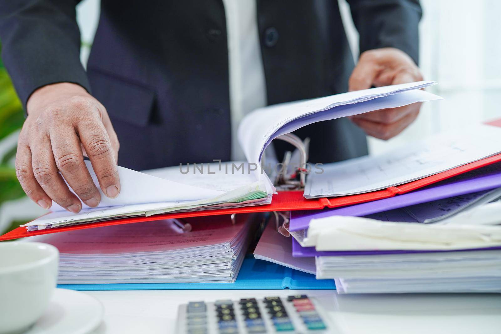Businessman working and prepare paperwork report data to analysis information in file binder at office.