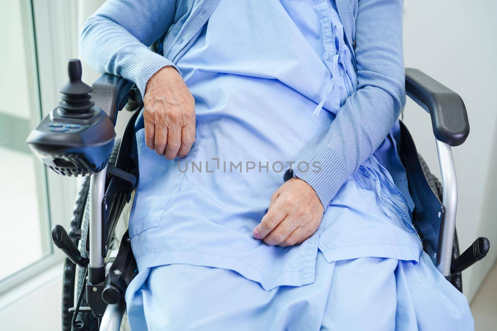 Asian elderly woman disability patient walk with walker in nursing hospital, medical concept.