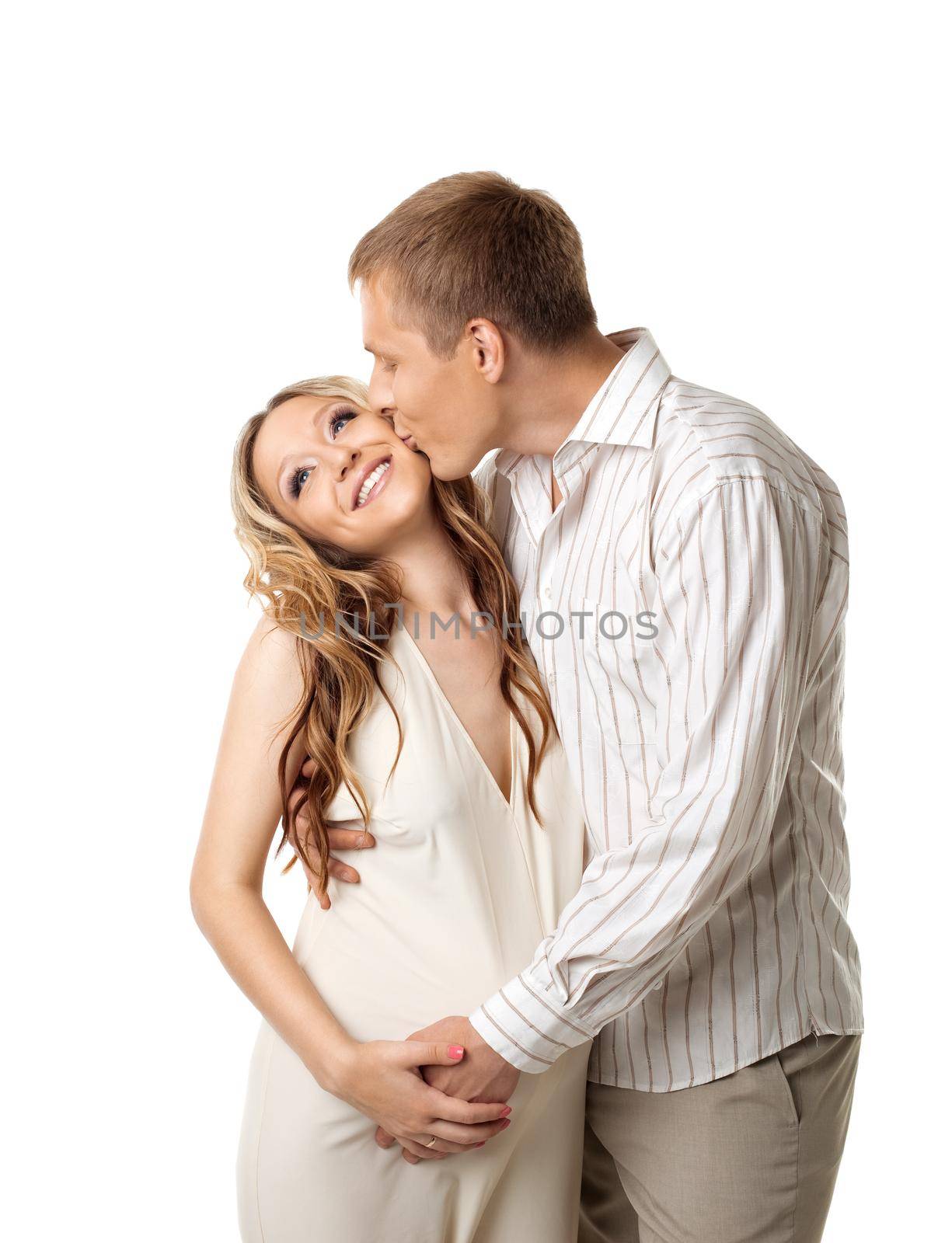 Young happy couple in white wait for baby - man kiss a whife
