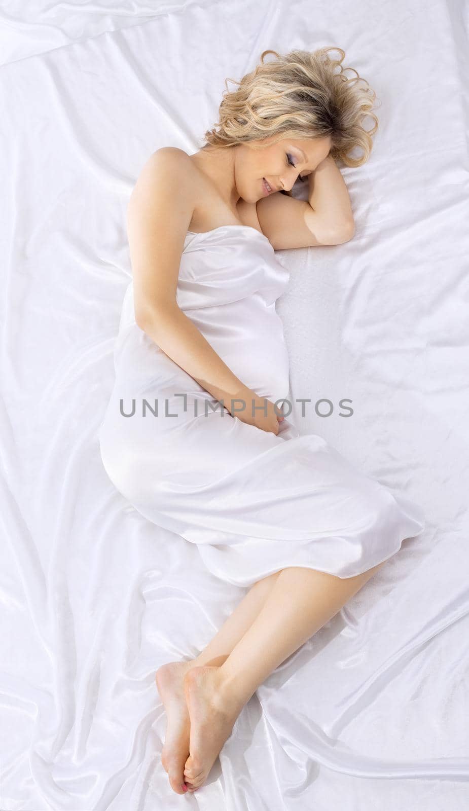 Yong beauty pregnant woman lay on white bed by rivertime