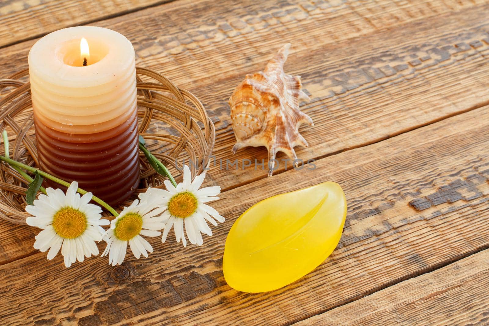 Perfume, candle, gift box and fresh flowers on wooden table. by mvg6894