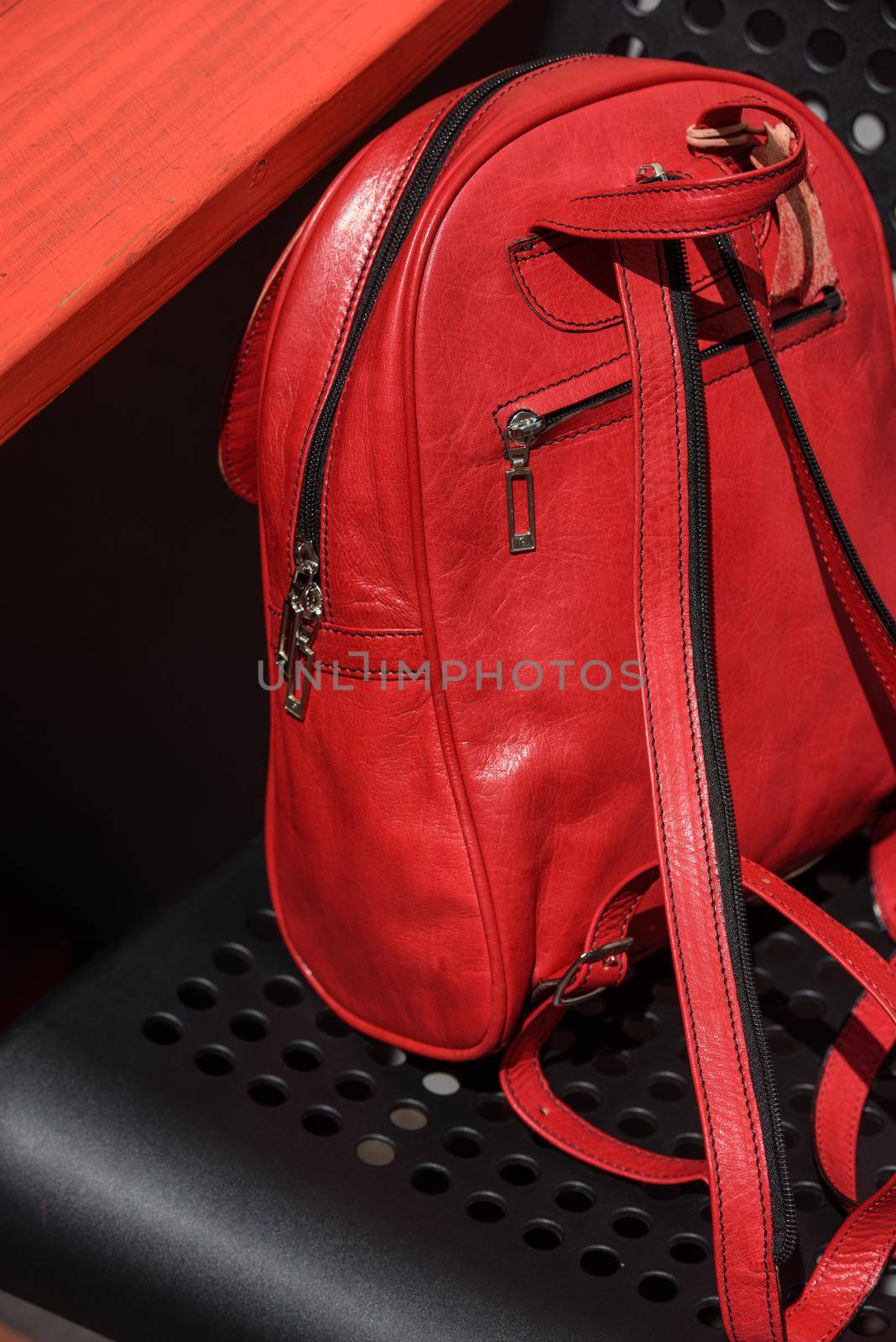 Red leather casual unisex backpack on a black chair by Ashtray25