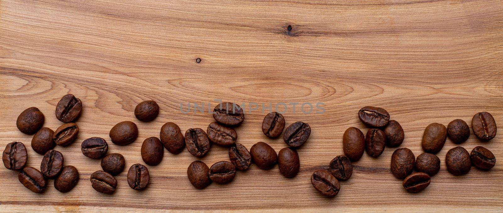 Coffee beans on a wooden background banner, place for the inscription