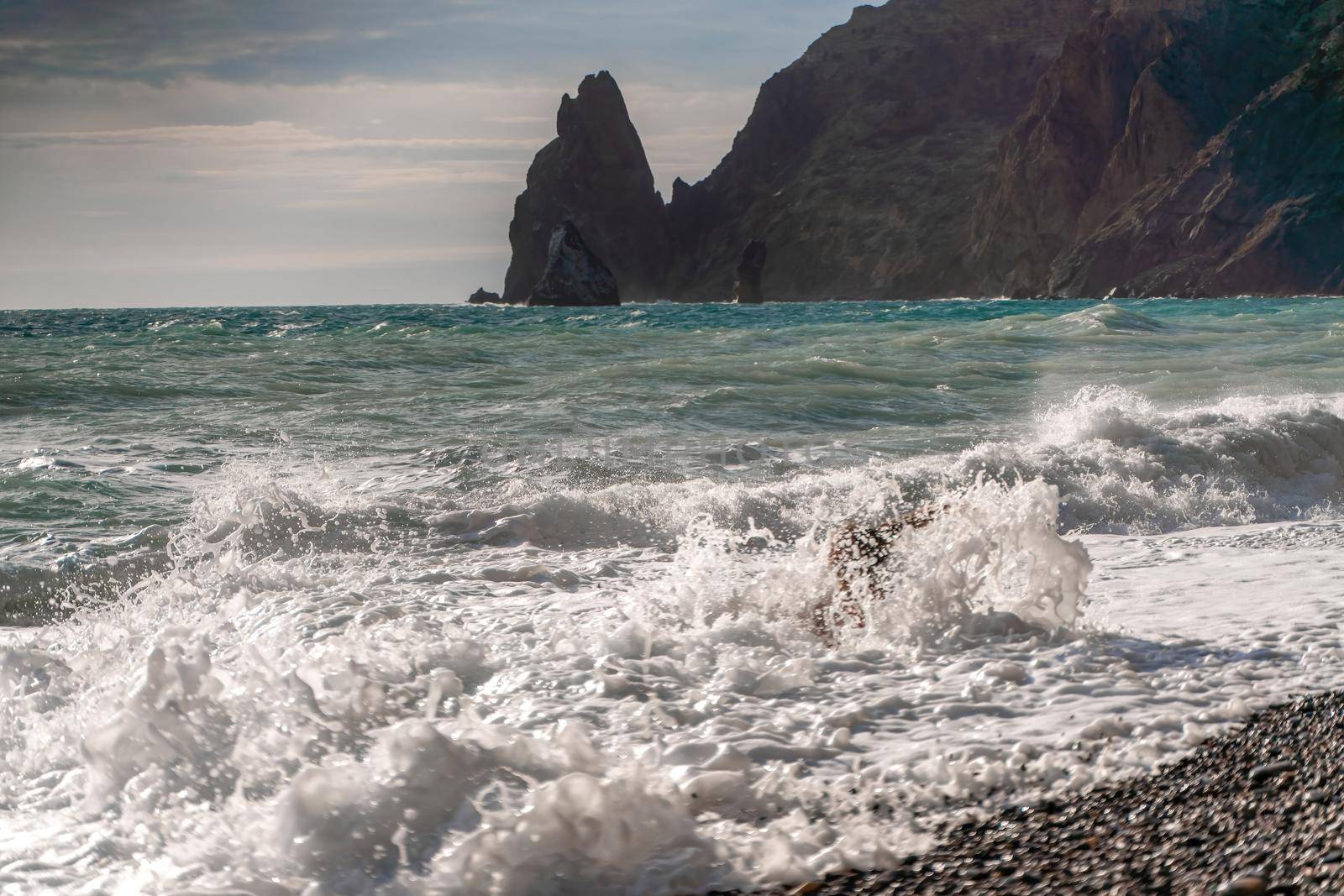 A stormy sky over a green sea in the background with sunlight coming from the south. In the foreground, white foam waves. by Matiunina