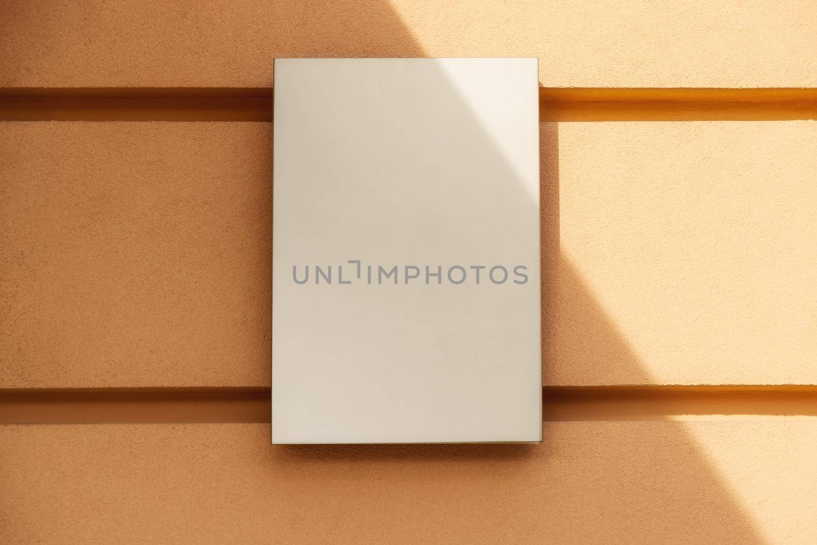 mockup for logo. square, empty, classic signboard against a yellow wall by Ramanouskaya