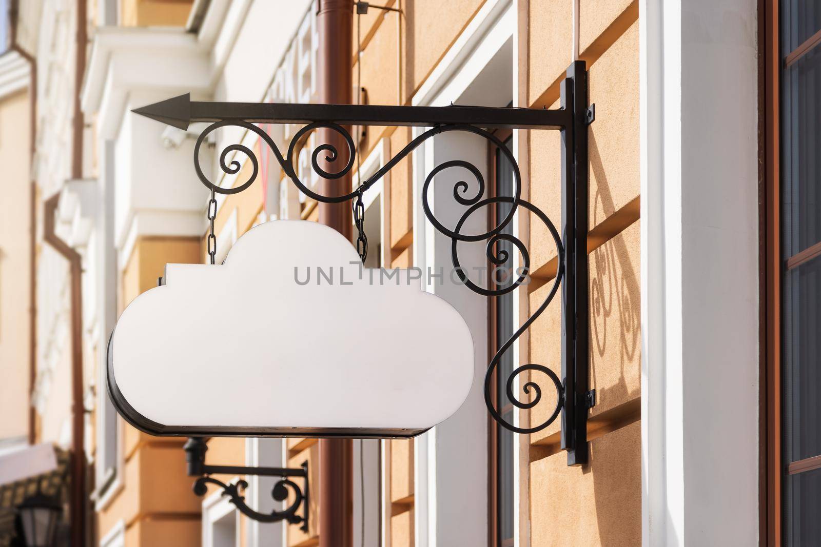 mockup, white signboard, in the form of a cloud, classic style. for a restaurant or cafe on the house, against the backdrop of the old city street. open a sign style to add a sign or company logo