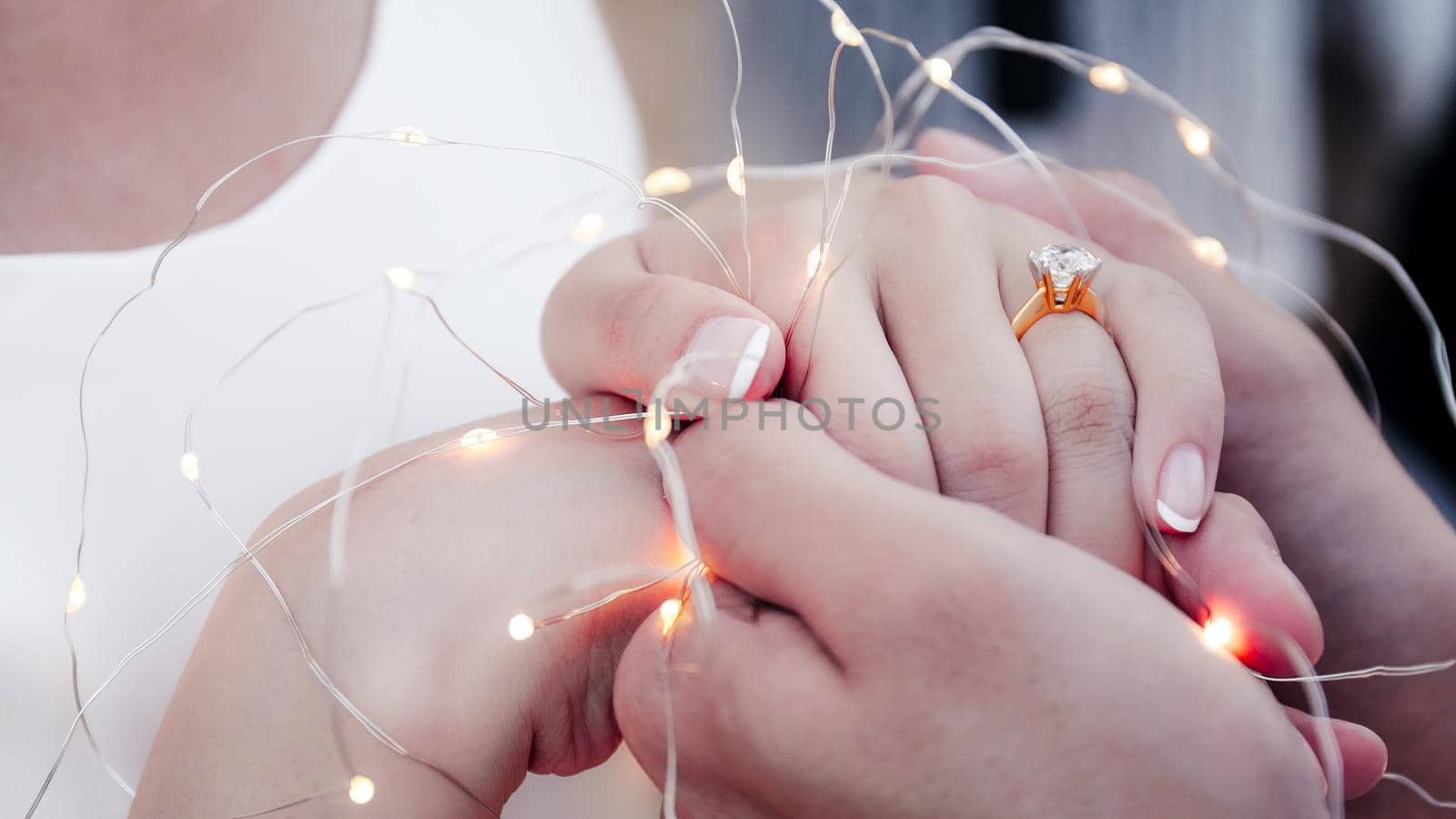 Close up ans soft focus selective ring. Wedding photograph young couple of lovers who are just married, are close to each other in harmony, love and happiness. Groom holds the bride's hand in his hand.