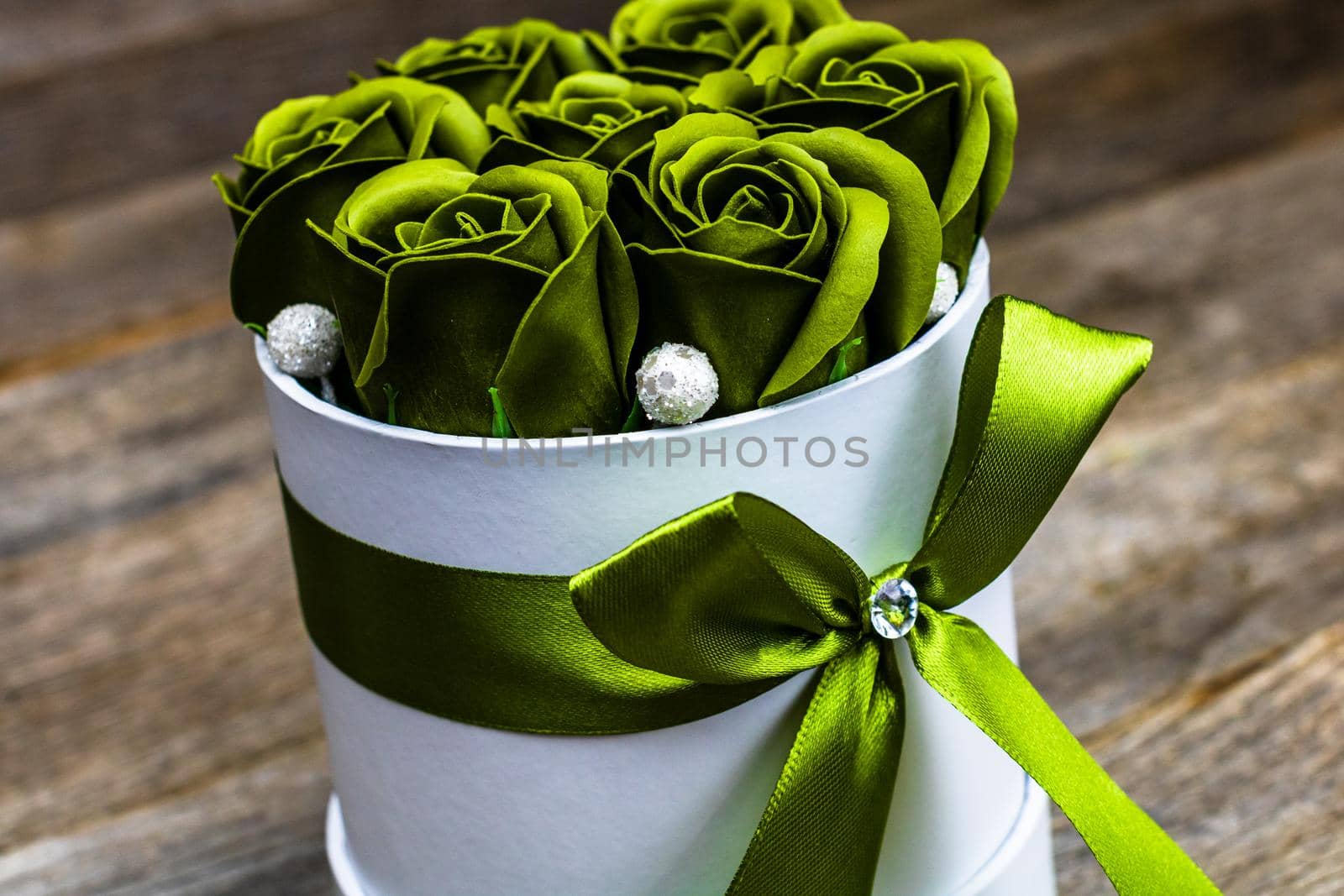 Green roses in a round luxury present box. Bouquet of flowers in a paper box isolated. by vladispas