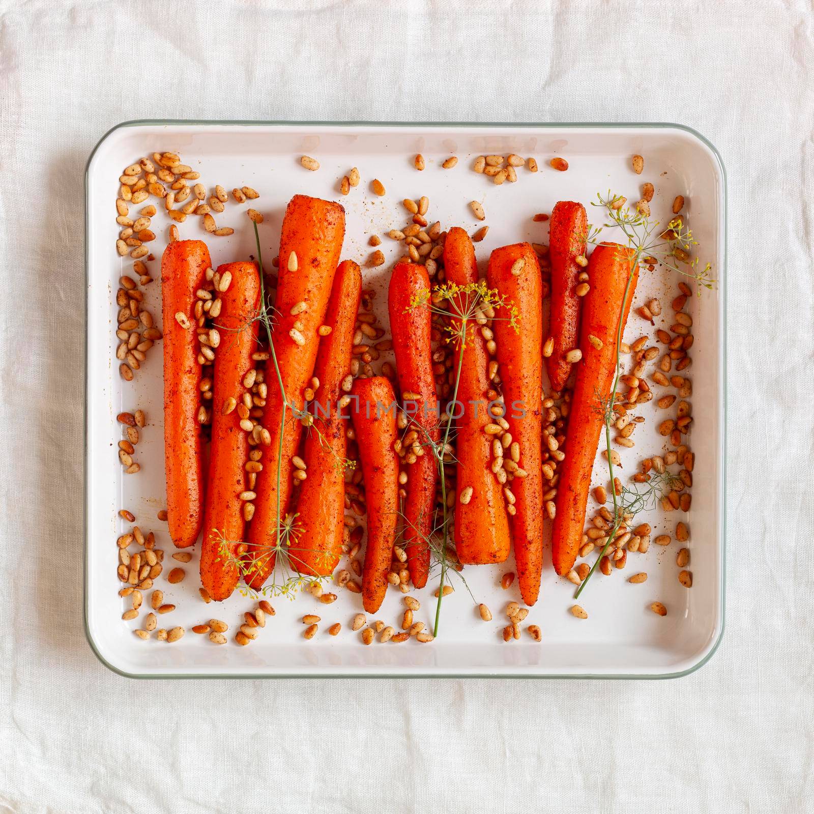 Lebanese-style carrots prepared with pine nuts and cumin and decorated with dill branches, top view