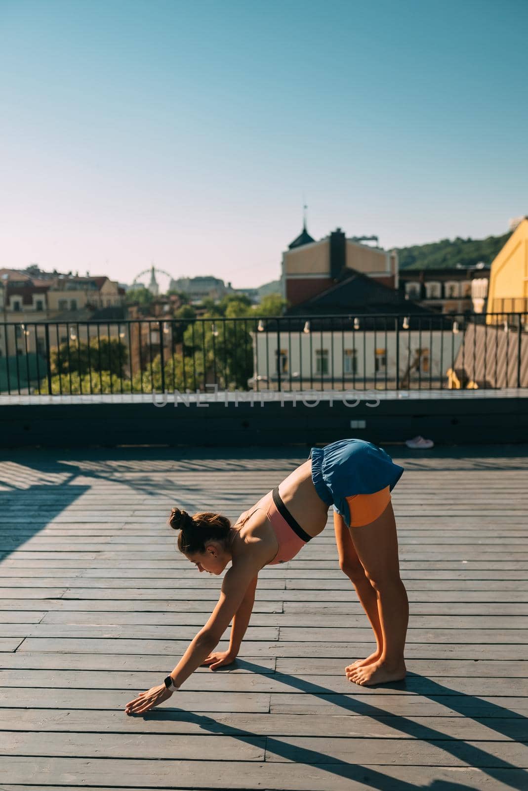 Young woman practicing yoga on the roof