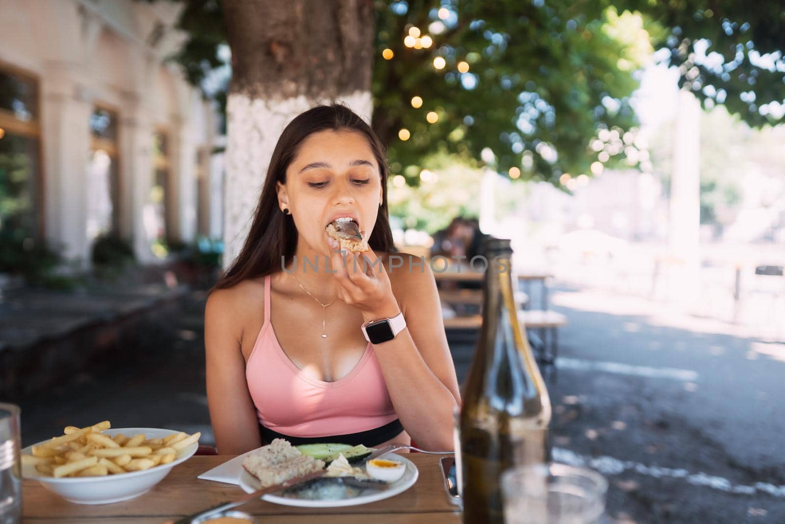 Woman having breakfast cin street cafe outdoors